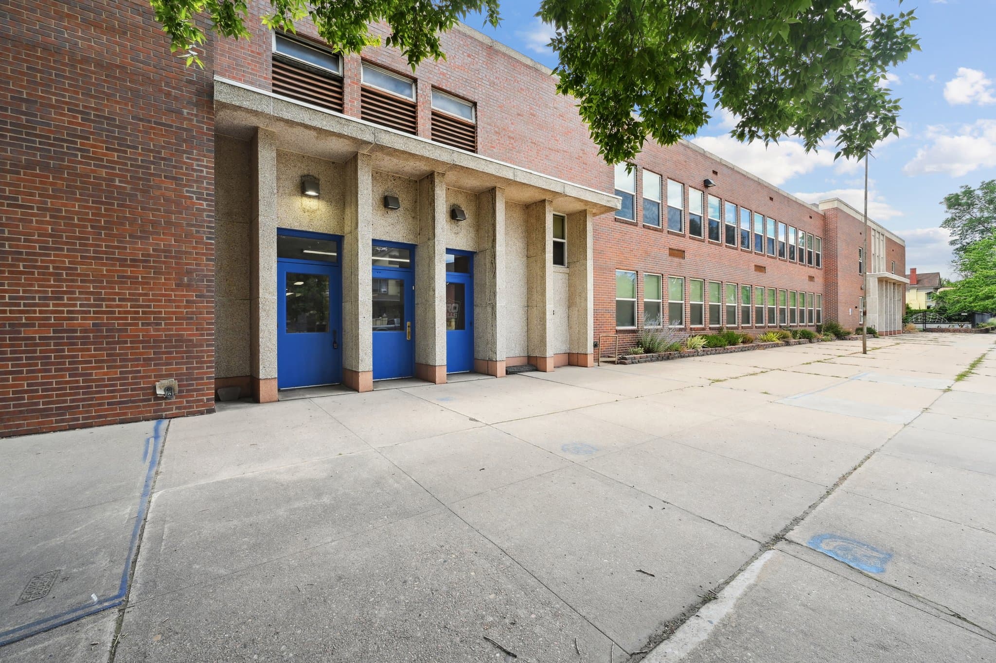Brick institutional campus with blue entry doors